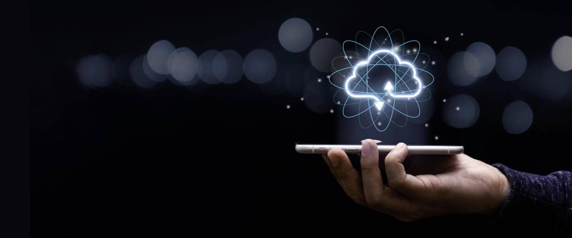 Hand holding a phone with glowing cloud graphic